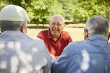 smiling senior man with friends